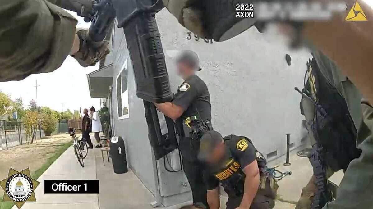 Deputies respond to a hostage situation at a south Sacramento home on Oct. 18, 2022. The suspect in the incident, Vincent Martinez, 55, is seen at left holding a shotgun in an image taken from a body-worn camera. Deputies shot and skilled Martinez.