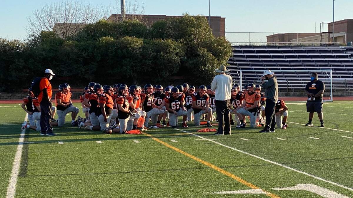 New Roseville football head coach Adam Reinking talks to his team after practice. The Tigers open the season against Christian Brothers on Friday.