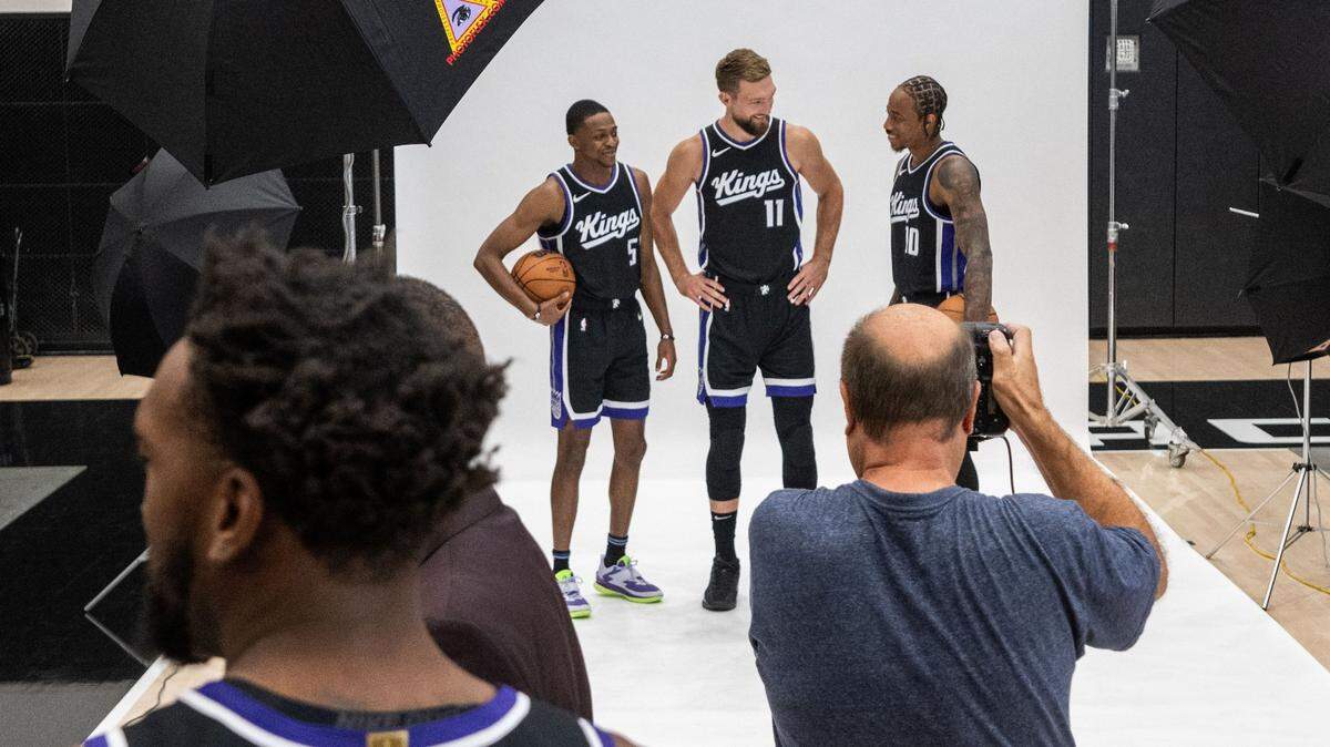 Sacramento Kings guard De’Aaron Fox (5), forward Domantas Sabonis (11) and forward DeMar DeRozan (10) stand for a photo for Kings photographer Rocky Winder during media day on Monday.