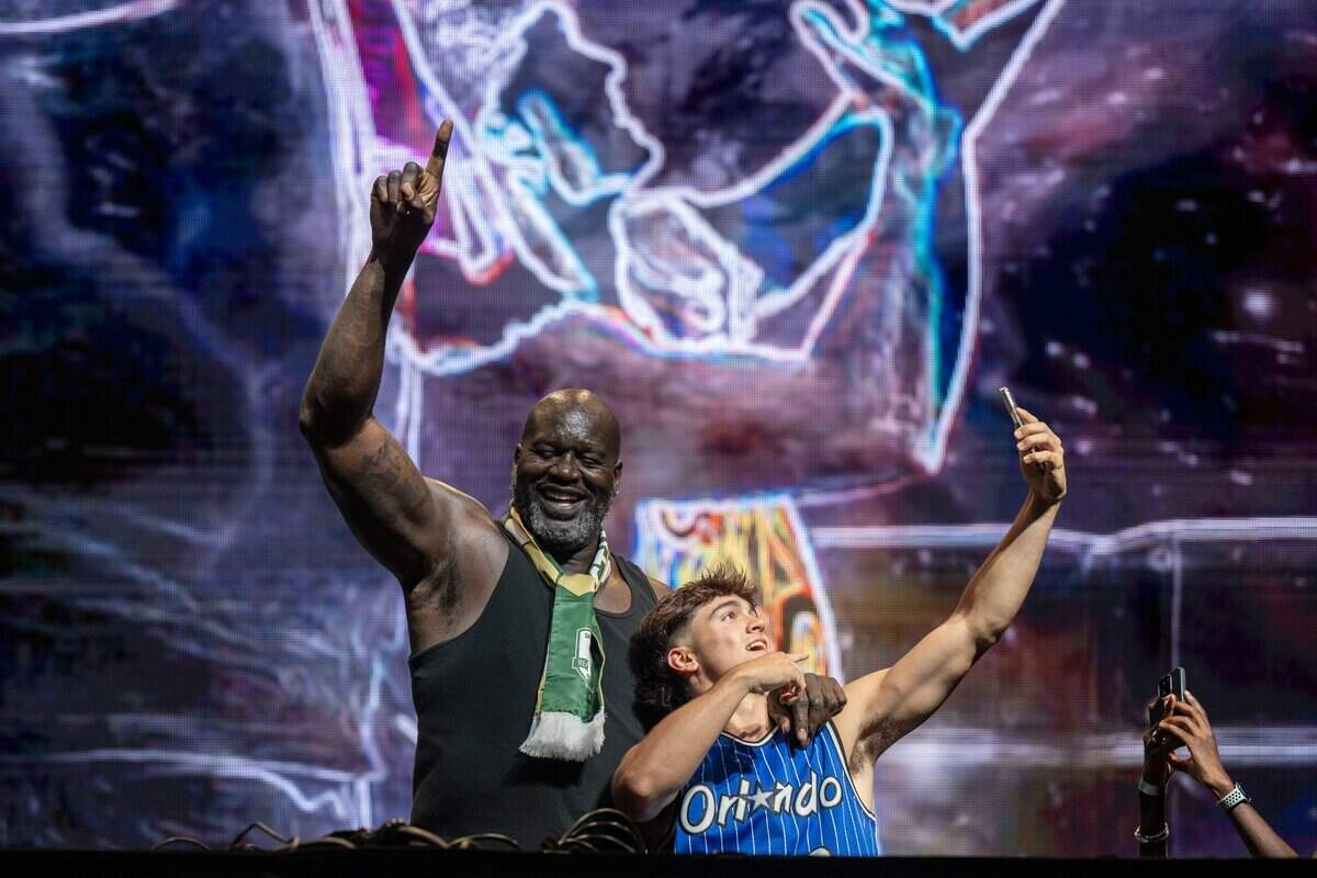 Shaquille O’Neal, aka DJ Diesel, brings a fan onto the stage during his performance at Heart Health Park in Sacramento on Friday.