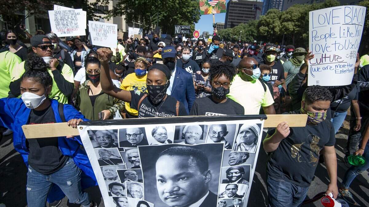 Thousands of protesters march down Capitol Mall in Sacramento, Saturday, June 6, 2020, from Golden 1 Center to protest the killing of George Floyd.