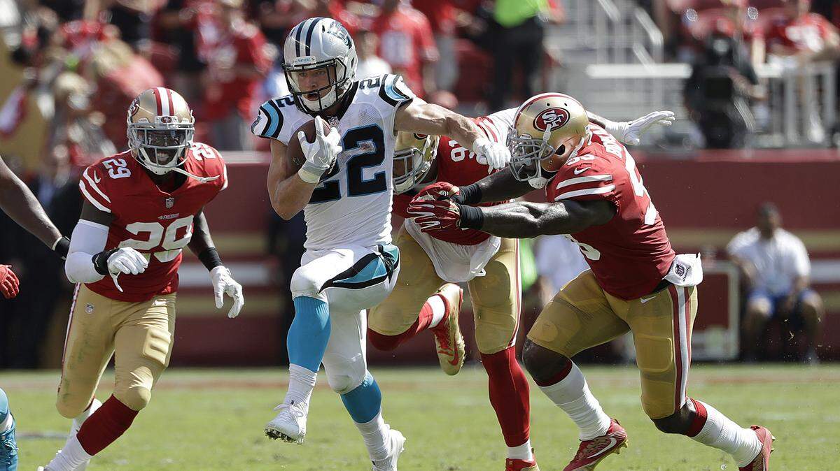 Carolina Panthers running back Christian McCaffrey (22) runs against the 49ers in a September 2017 game at Levi’s Stadium.