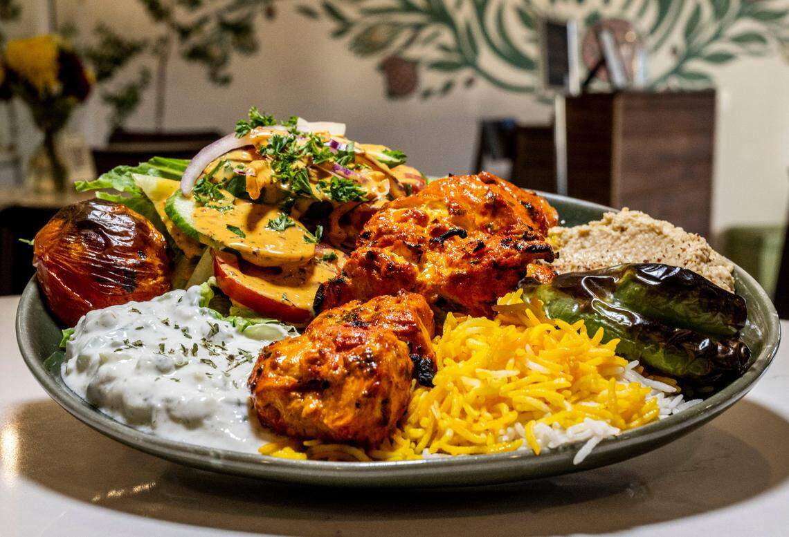 A Taste of Maydoon plate which includes chicken served with mixed greens, must khiar, hummus, pita and rice on Thursday, Nov. 17, 2022.