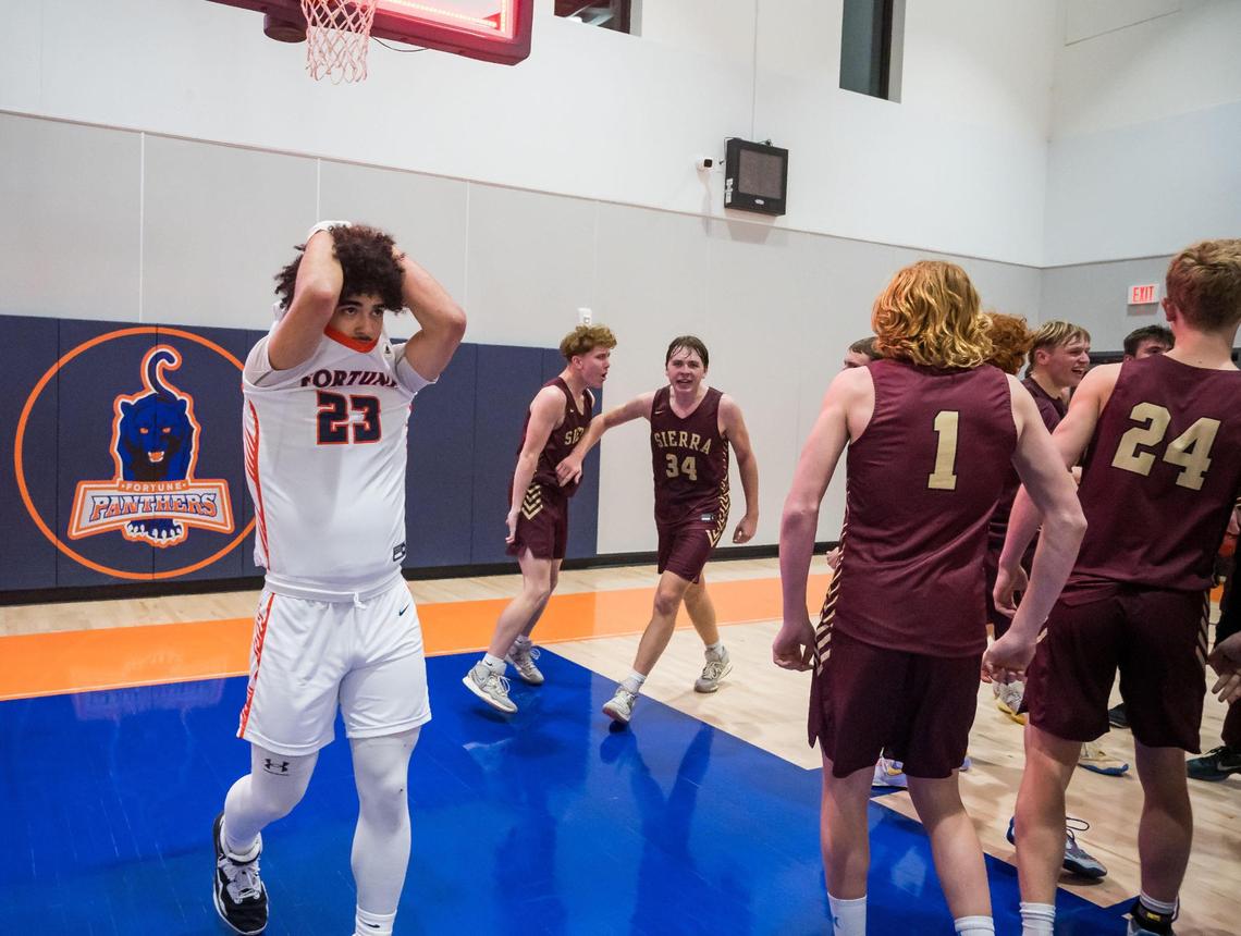 Fortune Panthers guard Tyree Rose (23), left, walks away as Sierra Chieftains guard Logan Kilbert (34), center, celebrates with teammates after scoring the game-winning basket at the CIF NorCal Division V high school boys basketball playoff game Thursday, March 2, 2023, at Fortune High School in Elk Grove.