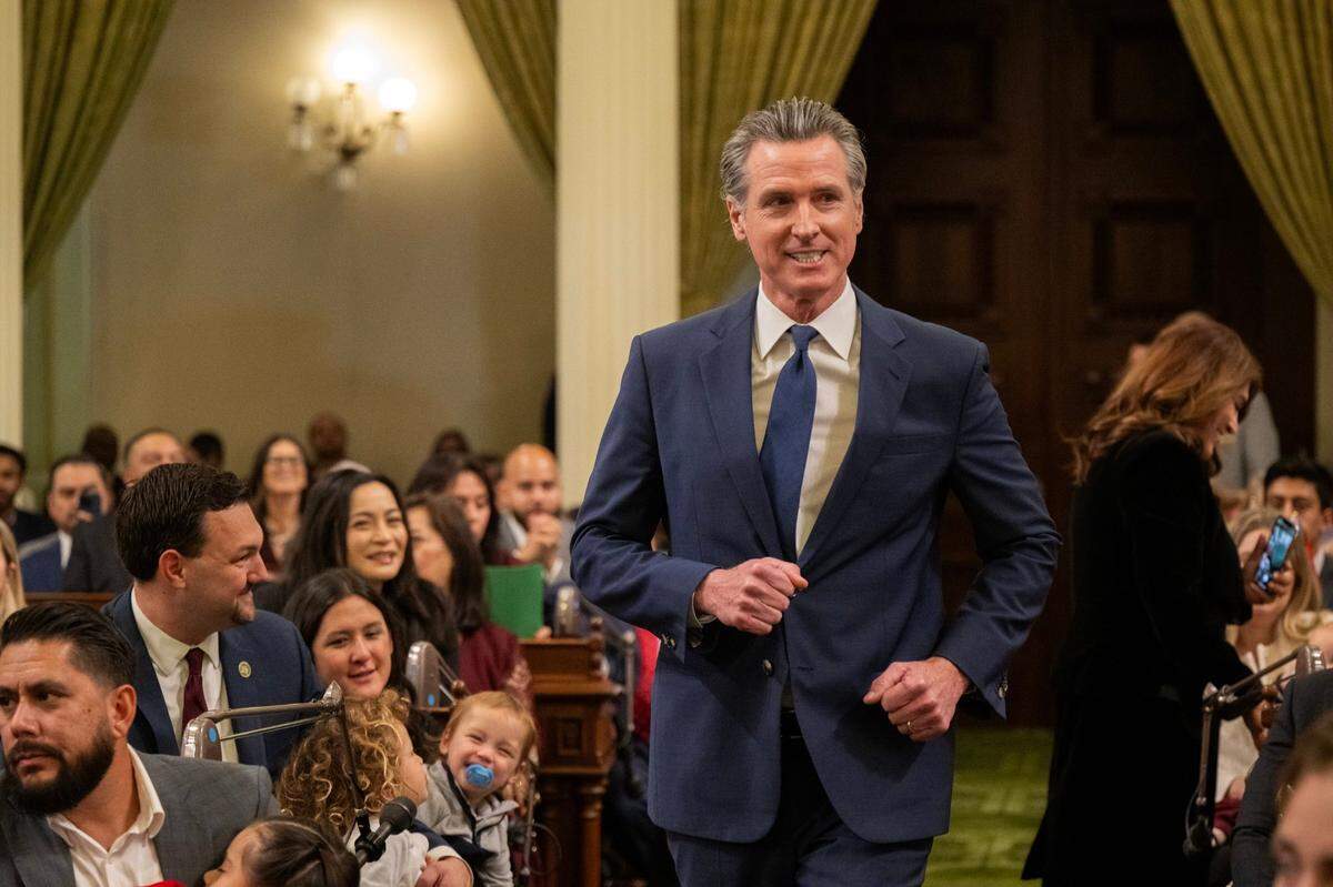 Gov. Gavin Newsom jogs down the aisle during at the state Capitol during the Assembly’s first meeting of the new legislative session on Monday.