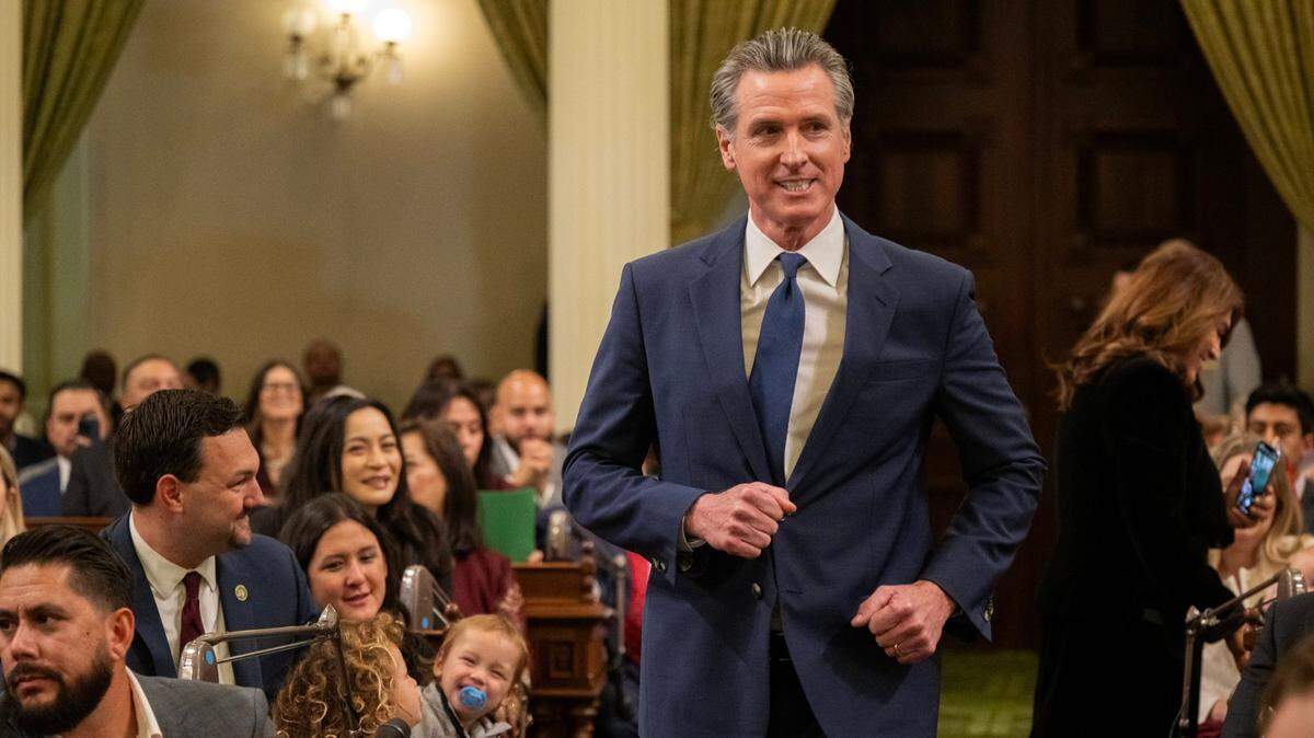 Gov. Gavin Newsom jogs down the aisle during at the state Capitol during the Assembly’s first meeting of the new legislative session on Monday, Dec. 2, 2024.