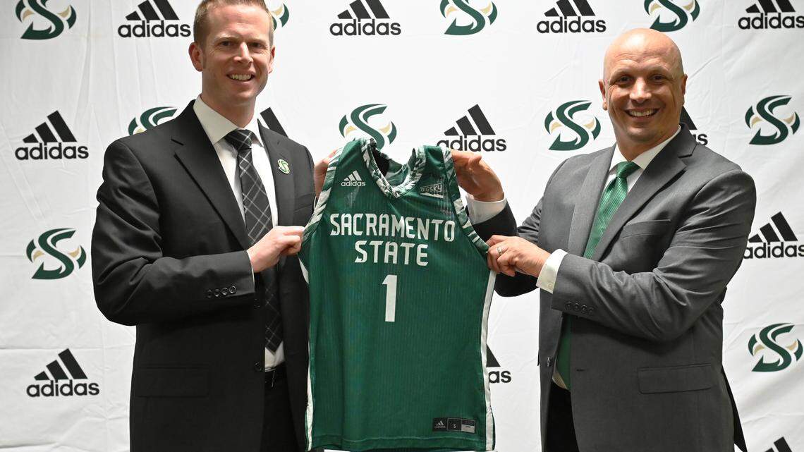 Sacramento State athletic director Mark Orr, right, presents women’s basketball head coach Mark Campbell with a commemorative jersey on Wednesday, April 21, 2021.