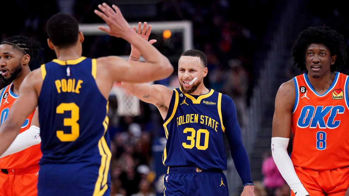 Golden State Warriors guard Stephen Curry (30) congratulates guard Jordan Poole (3) after a play against the Oklahoma City Thunder in the fourth quarter at the Chase Center on April 4, 2023.