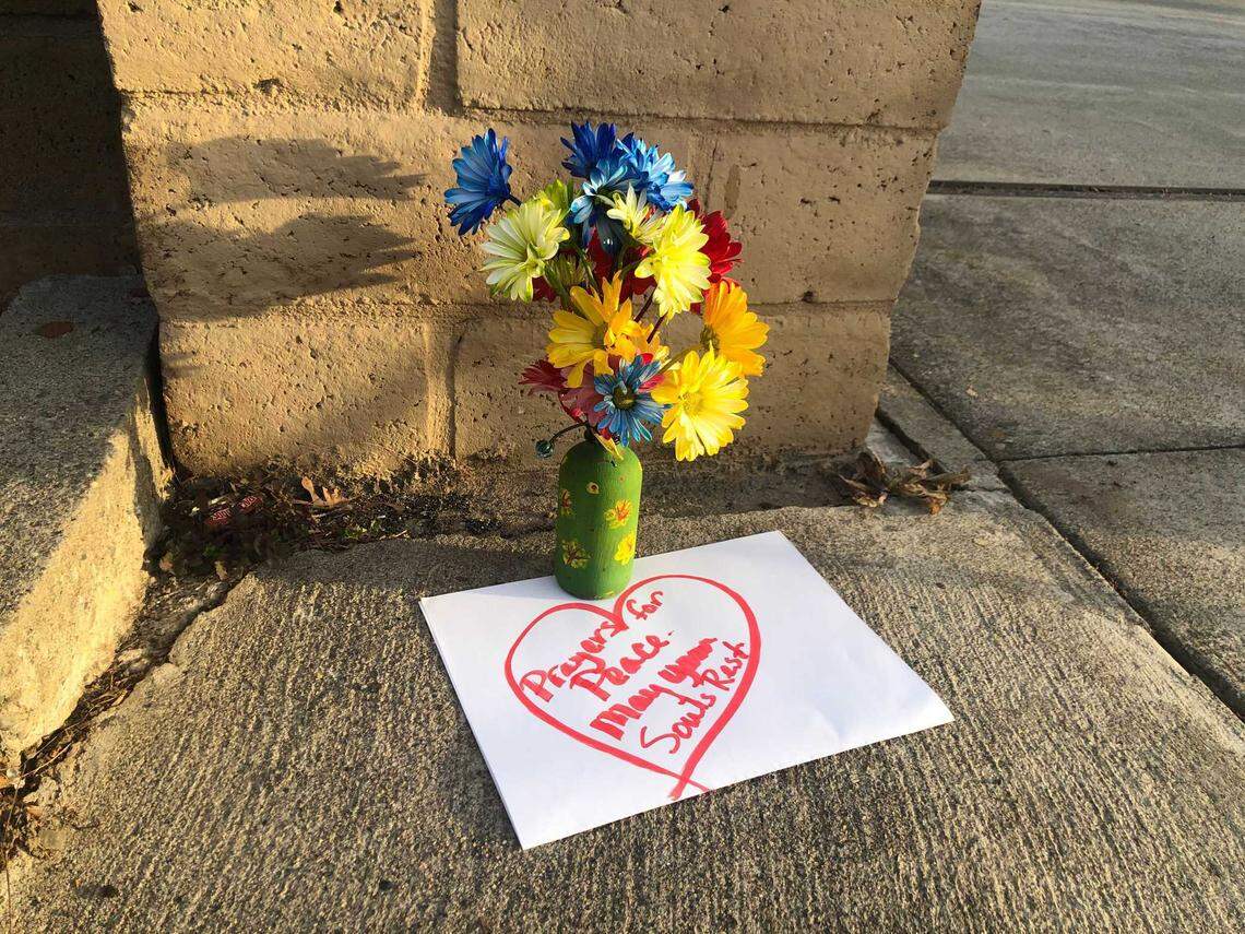 A bouquet of flowers was left at the gate to The Church in Sacramento’s front entrance on Wyda Way on Tuesday, March 1, 2022, hours after a gunman killed his three daughters and a chaperone inside the church.