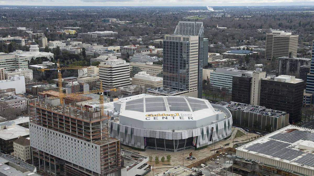 The Kimpton Sawyer hotel rises in 2017 next to Golden 1 Center and the Macy’s building in Downtown Commons in Sacramento.