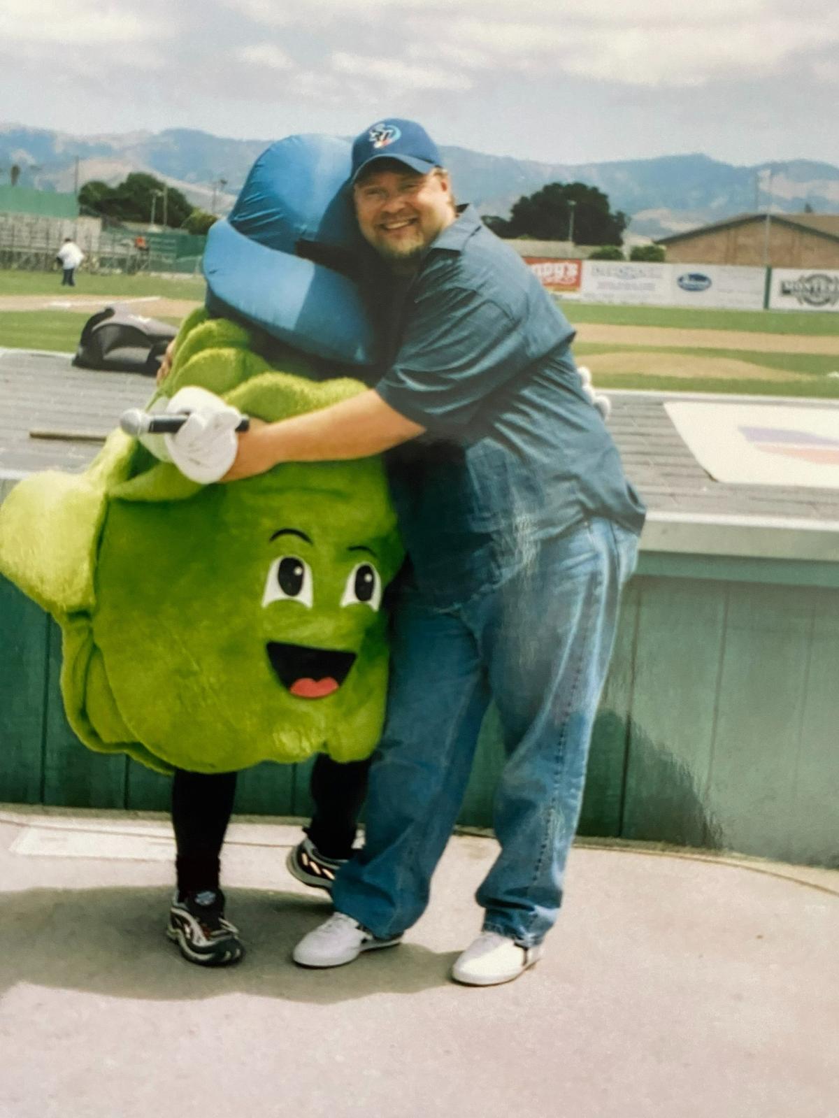 “Leafy” is hugged by a play-by-play announcer.