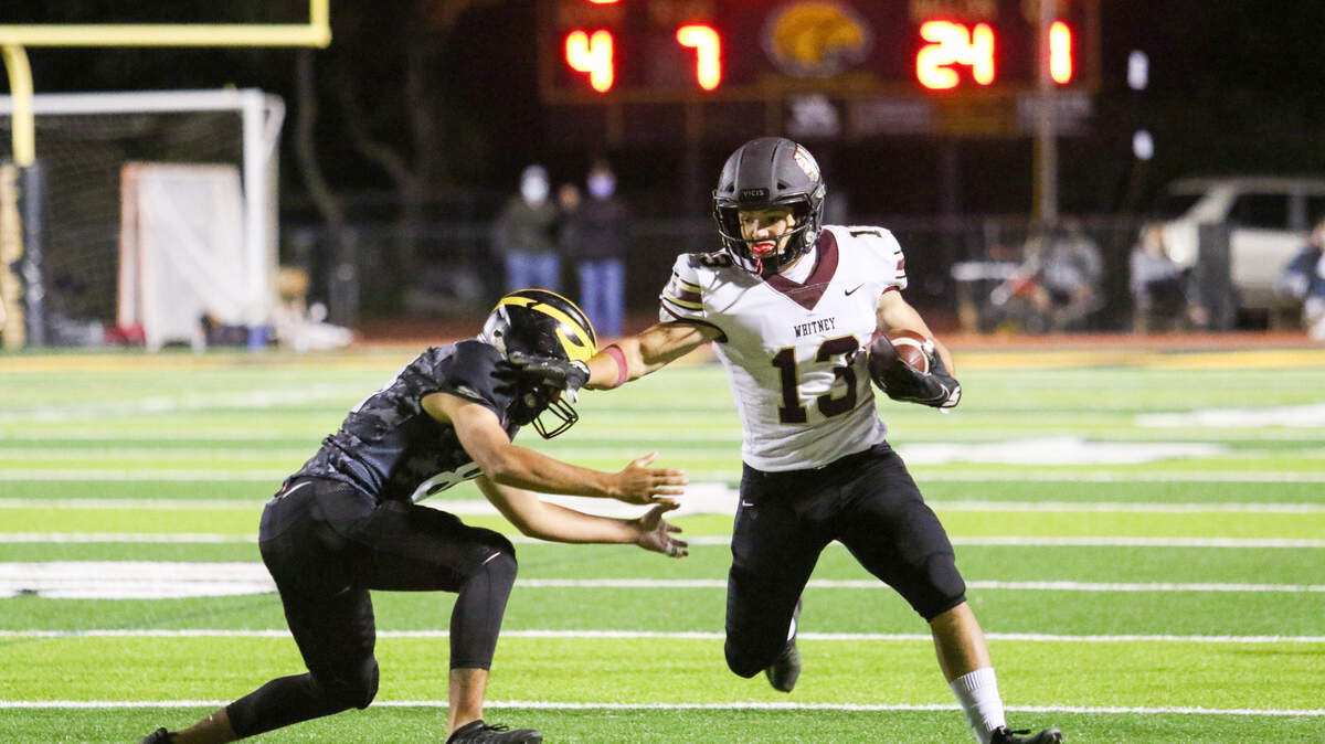 Whitney’s Nick Tawney avoids a Del Oro tackler on Friday during a 28-13 Whitney win.