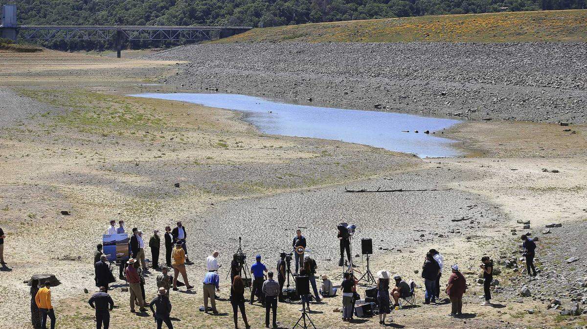 Gov. Gavin Newsom talks with reporters at the bottom of parched Lake Mendocino in Ukiah in April, when he proclaimed a drought emergency in Mendocino and Sonoma counties. The entirety of California has been in a state of drought since May.