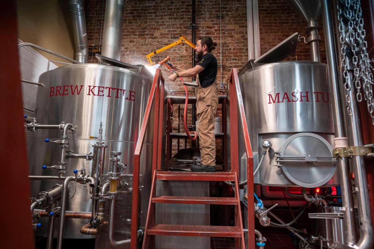 Justin Carapella a lead brewer at Auburn Alehouse works on lautering the beer on April 5. Owners Brian and Lisa Ford were the first of a wave of important craft breweries to start in Auburn, which became the center of the Sacramento-area beer scene.