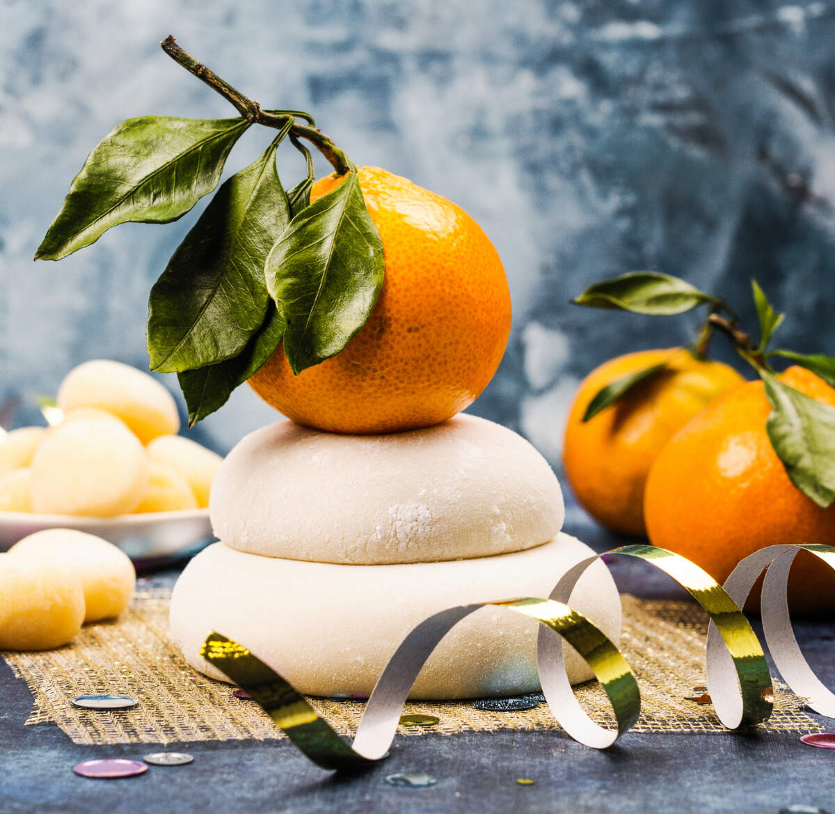 Traditional Japanese kagami mochi, a feature of a New Year’s Day holiday called Oshōgatsu, are topped with an unpeeled tangerine for prosperity.