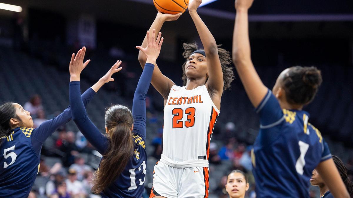 Central Grizzlies forward Talia Maxwell (23) shoots a jump shot while being triple teamed in the second half in the CIF State Division II Girls Basketball Championships on Saturday, March 11, 2023, at Golden 1 Center in Sacramento. The Grizzlies defeated the Barons 52-41.