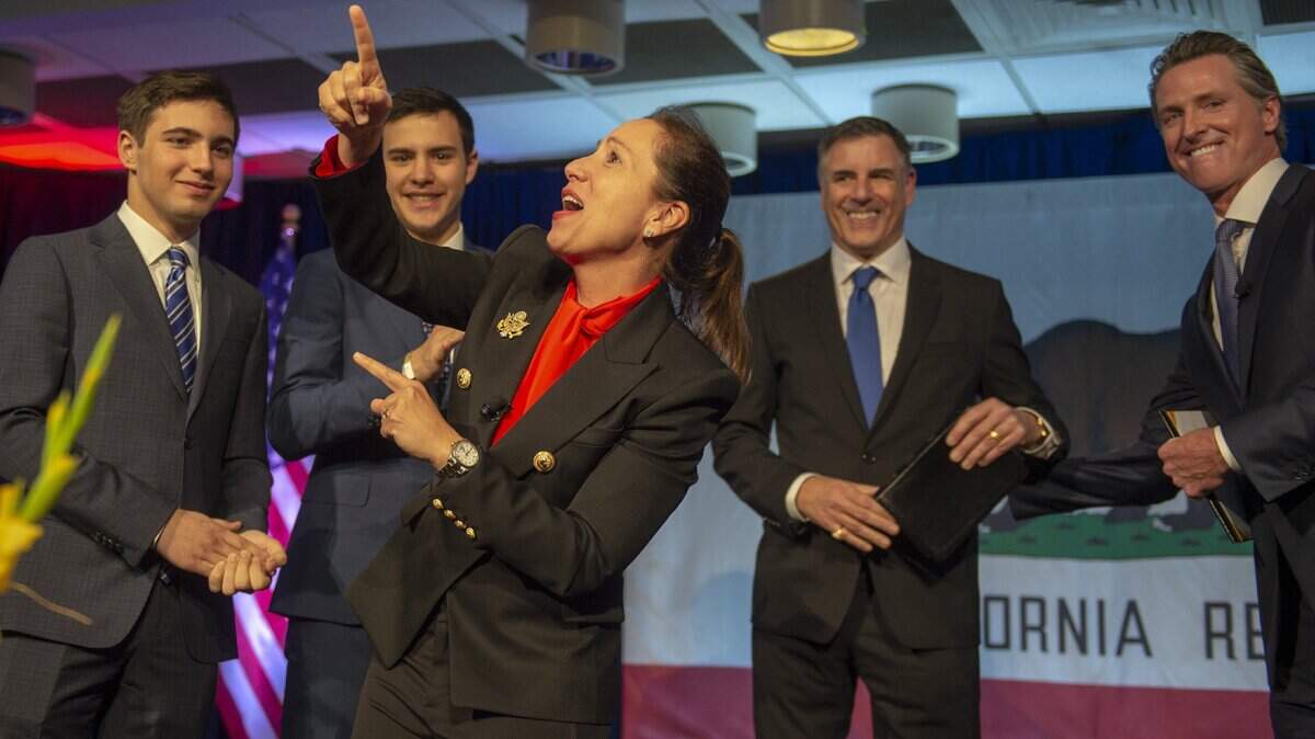 Eleni Kounalakis celebrates after being  sworn in as Lieutenant Governor with her sons (from left) Eon, Neo, husband Markos and Gov. Gavin Newsom at the Tsakopoulos Library Galleria on Jan. 7, 2019 in Sacramento.