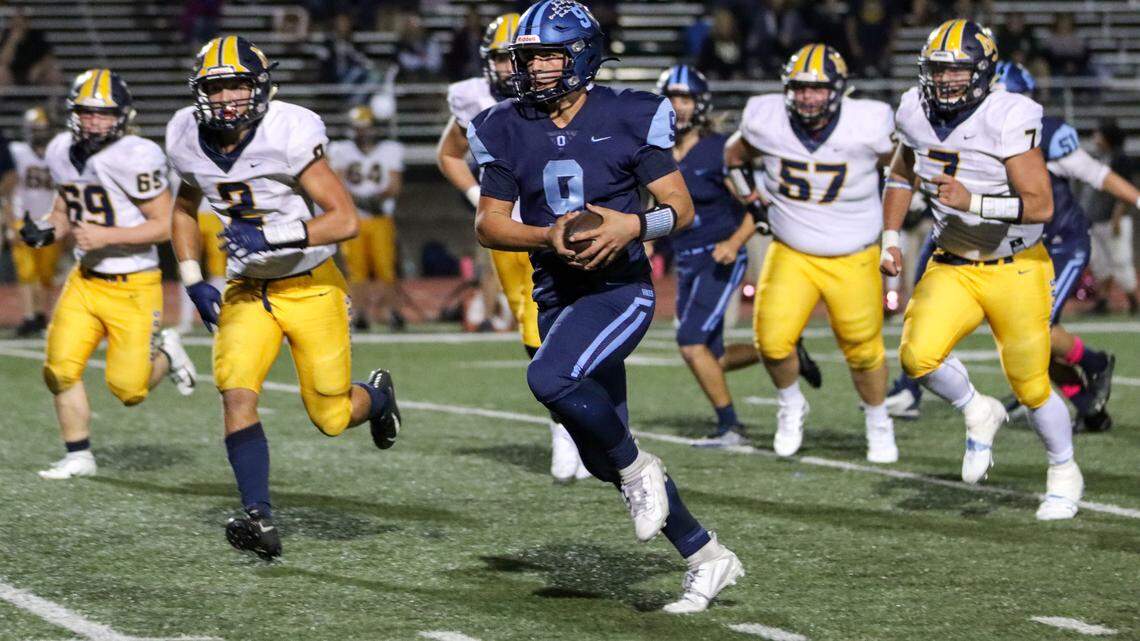 Oakmont quarterback Hayden Abbruzzese gallops past the Nevada Union defense during the Vikings’ 34-21 win Friday.