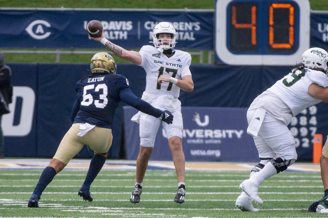 Sacramento State Hornets quarterback Carson Conklin (17) attempts to pass downfield as UC Davis Aggies linebacker Nick Eaton (53) puts pressure on him in the 2023 Causeway Classic.