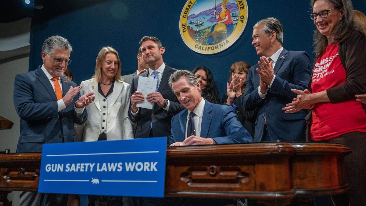 Gov. Gavin Newsom signs one of a series of bills to strengthen California’s gun control laws on Tuesday, Sept. 26, 2023. In question now is whether Newsom will sign a bill regulating artificial intelligence.