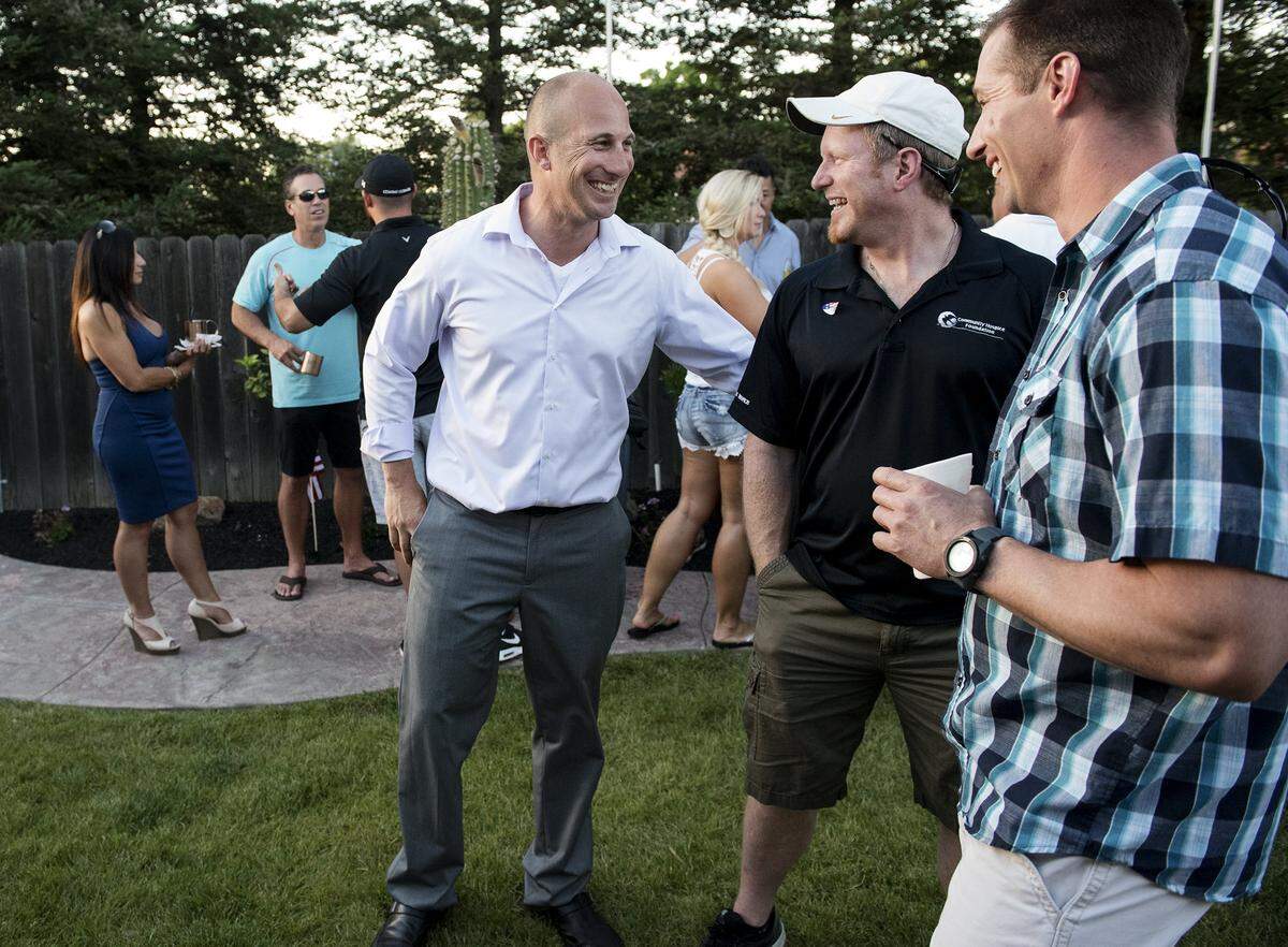 Assembly candidate Heath Flora greets Mike Gunnarson, middle, and his cousin Dale Flora, right, during an election night party at his home in Ripon in 2016.