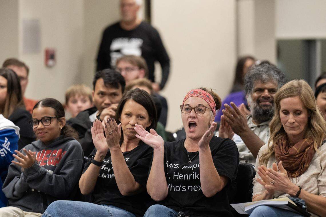 Brenda Buford and Leia Wallace, right, applaud after a speaker addressed the Sacramento City Unified School board on Thursday about the removal of Phoebe Hearst teachers Jeanine Rupert and Mark Henrikson by district administrators. Buford and Wallace have children who attend the elementary school.