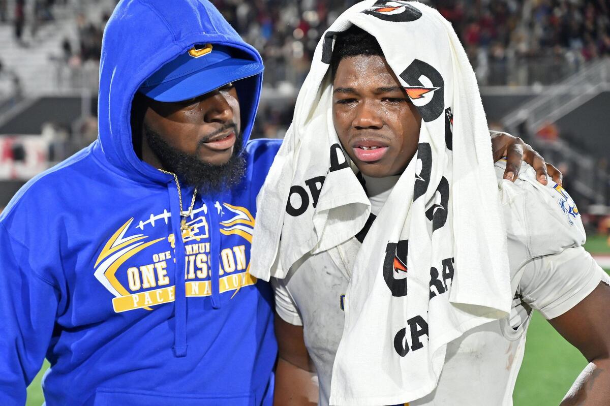 Grant High School assistant coach Deanthone Ferguson, left, consoles running back Wayshawn Parker (1) after the CIF Division 2-AA state football championship against the La Serna Lancers on Friday, Dec. 8, 2023, at Saddleback College in Mission Viejo.