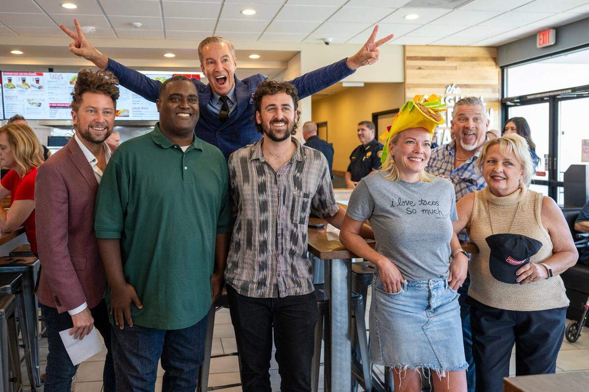 From left, Emcee, Patrick Harbison, Big Al of Good Day Sacramento, ABC10’s Mark S. Allen, Sacramento Bee’s Benjy Egel, KCRA’s Tamara Berg, Folsom Times’ Adam Frick, and Comstock’s Judy Farah stand before the Jimboy’s Tacos Eating Contest between local media personalities and dignitaries, competing against the CEO on Wednesday at Jimboy’s in Folsom.