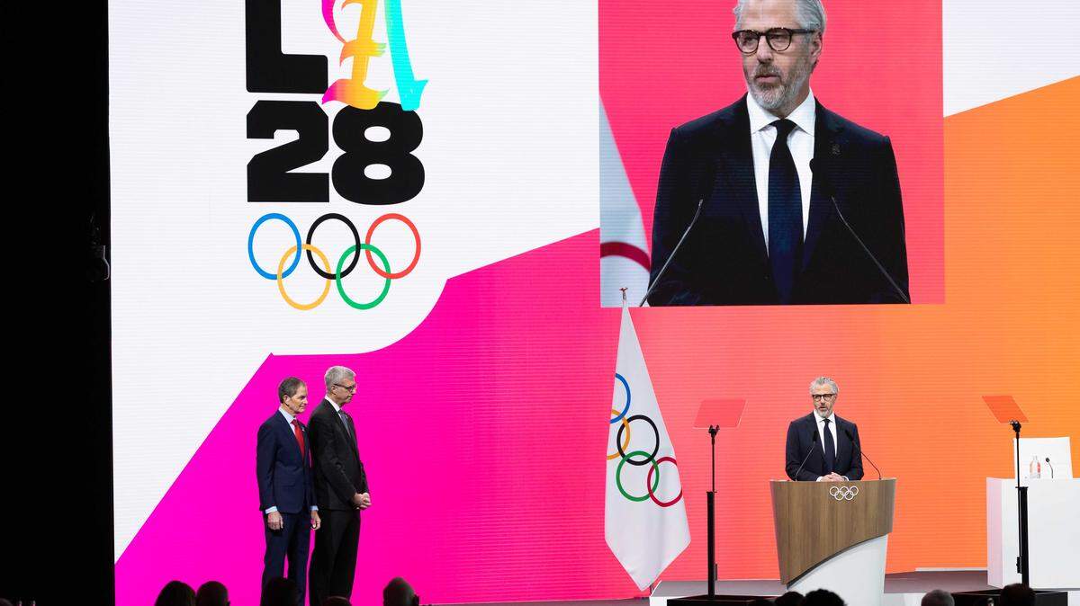 Casey Wasserman, center, chairman of LA28, speaks as International Olympic Committee member Gene Sykes, left, and LA28 CEO Reynold Hoover look on during an IOC session on Feb. 3 in Milan, Italy. Wasserman is preparing to sell the talent agency he founded after acknowledging that his appearance in recently released Jeffrey Epstein-related documents has become a distraction for the company and its clients.