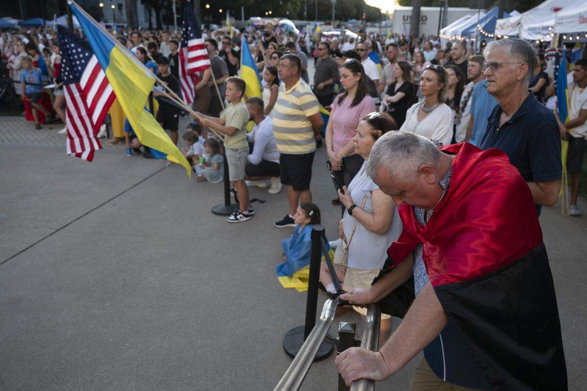 Ukrainian-Americans react to a video message from Ukrainian President Volodymyr Zelenskyy during a Ukrainian Independence Day celebration at the California Capitol in Sacramento on Sunday, Aug. 24, 2025.