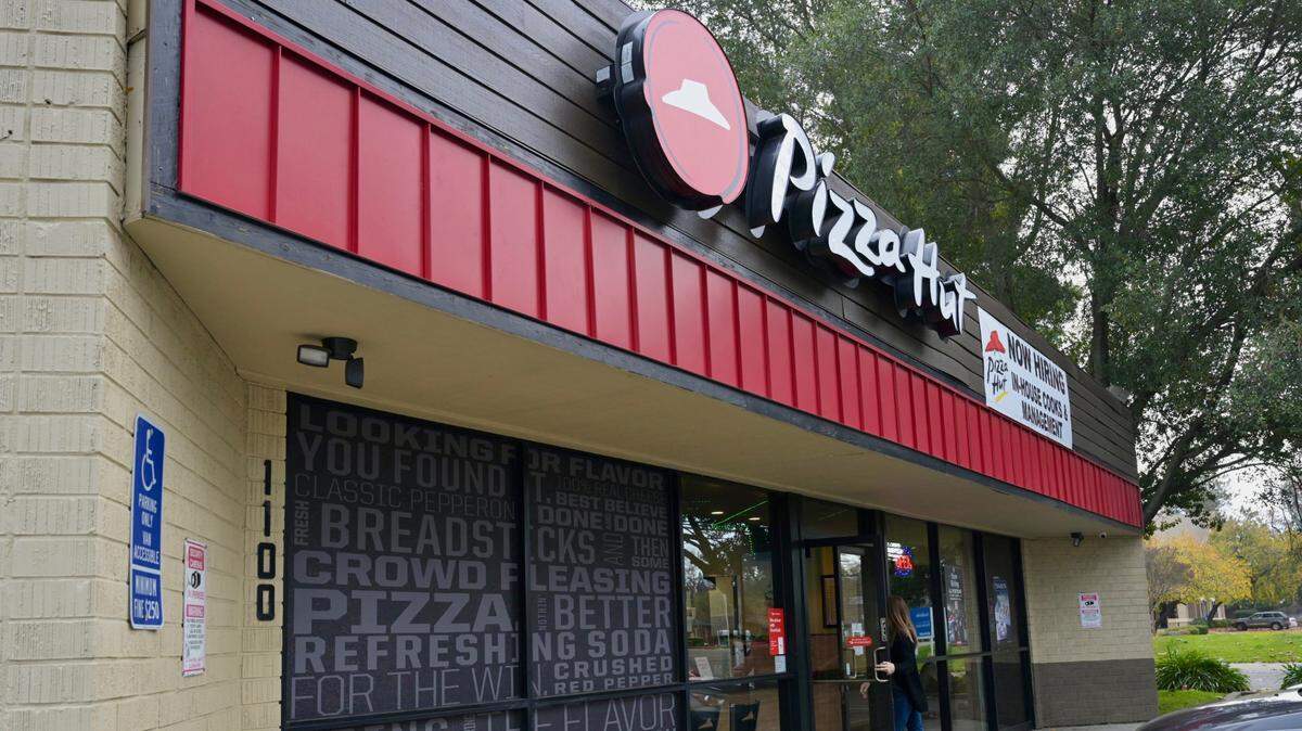 A customer enters the Pizza Hut at 1100 Fulton Ave. in Arden Arcade on Wednesday, Dec. 27, 2023. The owner of the Sacramento County franchise is laying off delivery drivers to avoid paying the $20 an hour rate required by a new state law for fast-food workers.