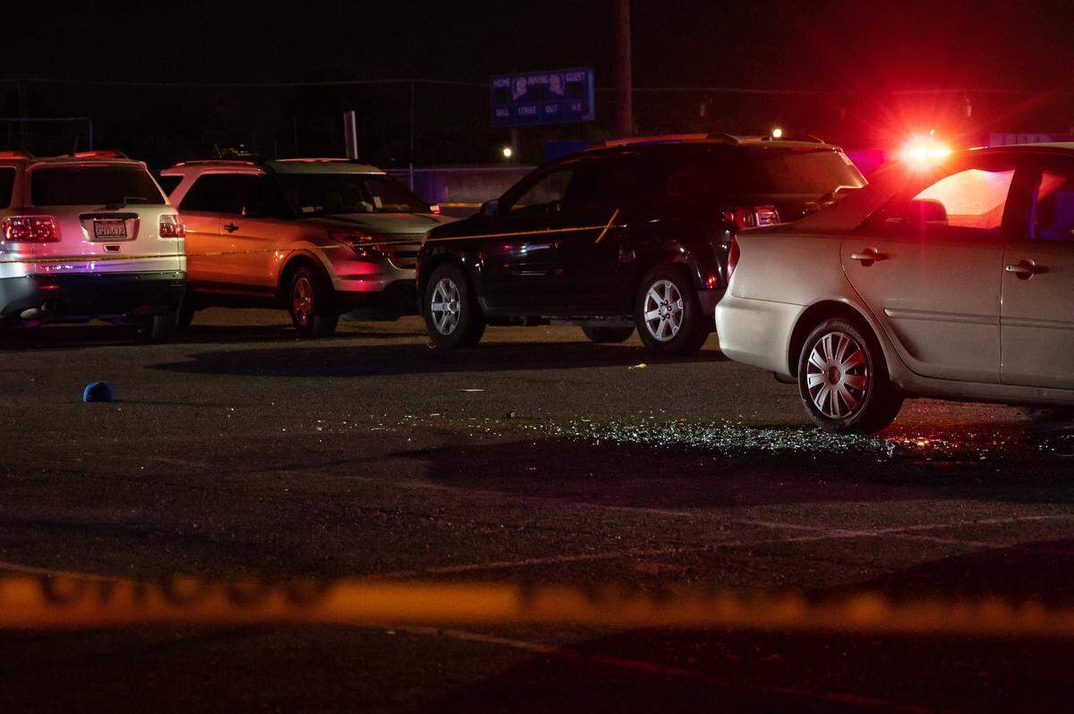 Shattered glass covers the parking lot outside the Grant High School gym after a shooting following the football team’s game against Monterey Trail High School on Friday, Oct. 21, 2022.