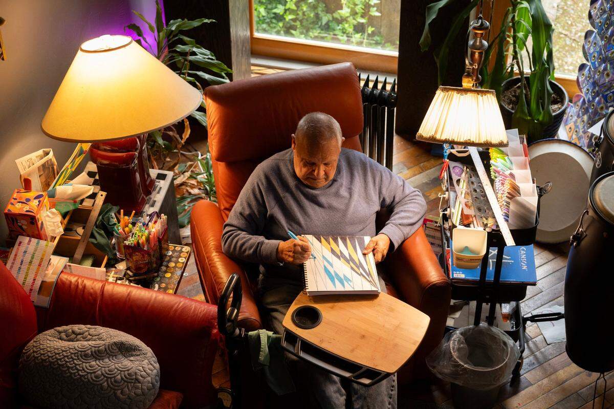 Carlos Olivas Jr. creates new art in his studio at home in Sacramento earlier this month.