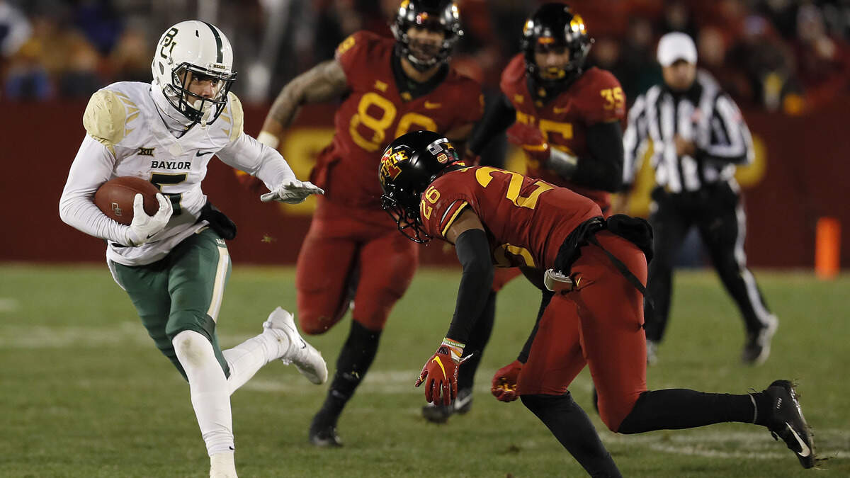 Baylor wide receiver Jalen Hurd, left, tries to elude Iowa State defensive back Anthony Johnson, right, during the second half of an NCAA college football game Saturday, Nov. 10, 2018, in Ames, Iowa. Iowa State won 28-14. (AP Photo/Matthew Putney)
