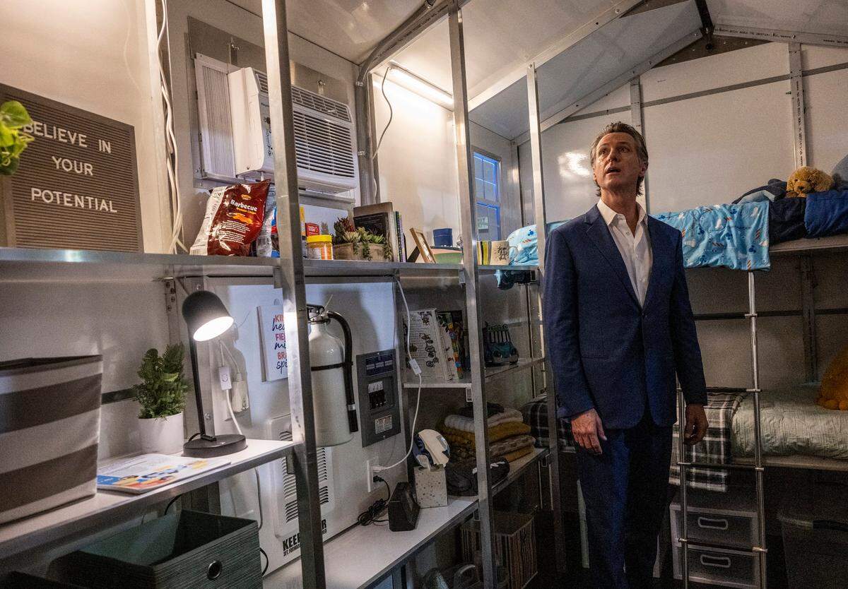 Gov. Gavin Newsom tours a tiny home after announcing last month that the state will have 1,200 tiny homes built and delivered throughout California in an effort to help house the homeless population.