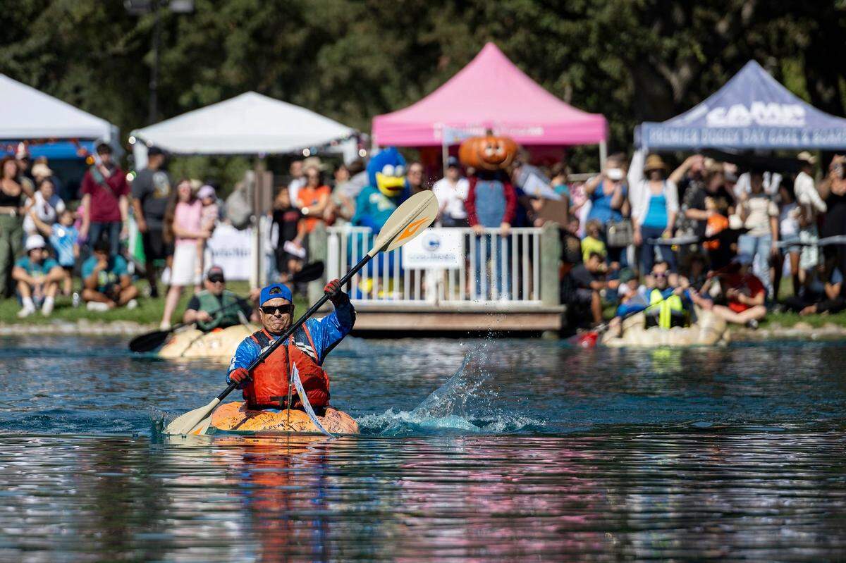 Johnny Gayton outpaces the other two contenders in the Pumpkin Regatta to win first place again at the Elk Grove Giant Pumpkin Festival on Sunday, Oct. 8, 2023, at Elk Grove Regional Park.