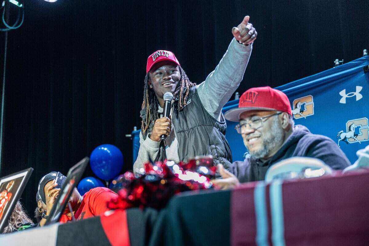 Grant High School running back Devin Green thanks his coaches before signing his letter to attend to UNLV on Wednesday during a National Signing Day event at the high school in Sacramento.