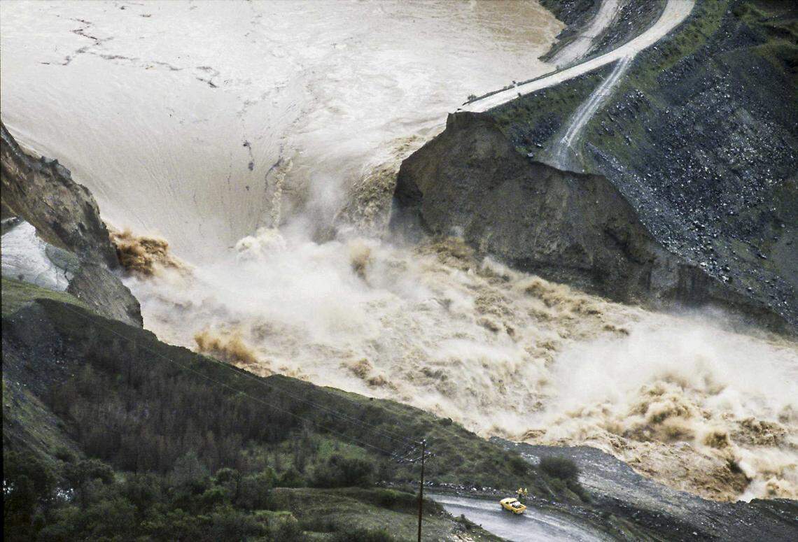 Raging water spews through a cofferdam that collapsed on the North Fork of the American River, dwarfing a pickup truck in 1986. The dam, built for the construction of the never-finished Auburn Dam, was designed as a temporary structure and its failure was expected.