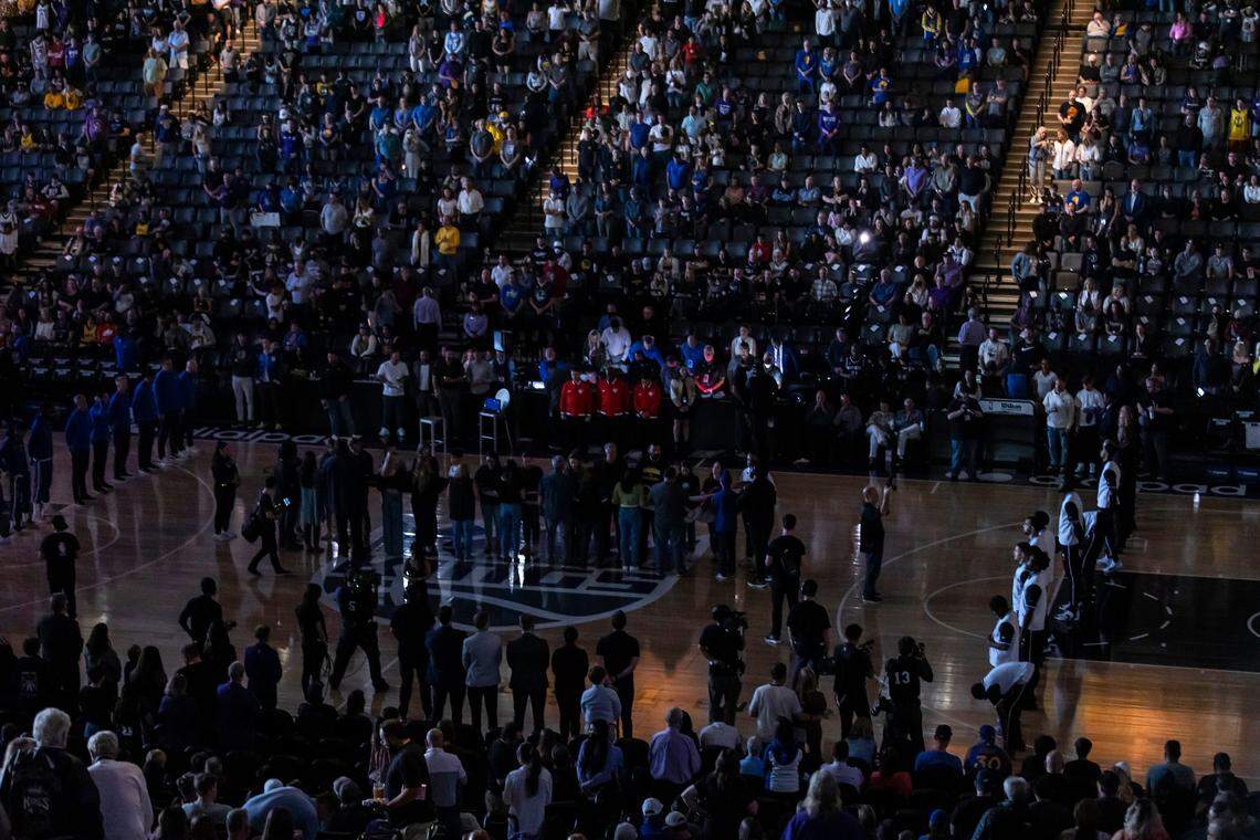 The Sacramento Kings and the Golden State Warriors stand on the court and participate in a moment of silence for the mass shooting victims on Sunday before an NBA basketball game at Golden 1 Center in Sacramento.