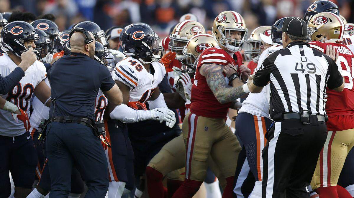 Coaches and officials try to separate Chicago Bears and San Francisco 49ers players in the second half in Santa Clara on Sunday, Dec. 23. Cornerback Richard Sherman of the 49ers was ejected from the game after this altercation.