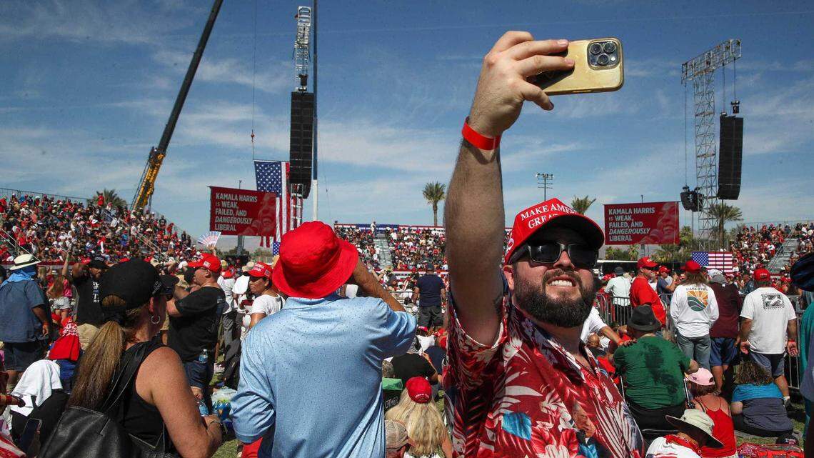 Trump supporter Angel Salazar takes a selfie while attending an Oct. 12 rally in Coachella. Thousands of Donald Trump supporters braved afternoon temperatures that briefly nudged 100 degrees. Trump and Republicans have been attracting more Latino voters frustrated with Democrats.