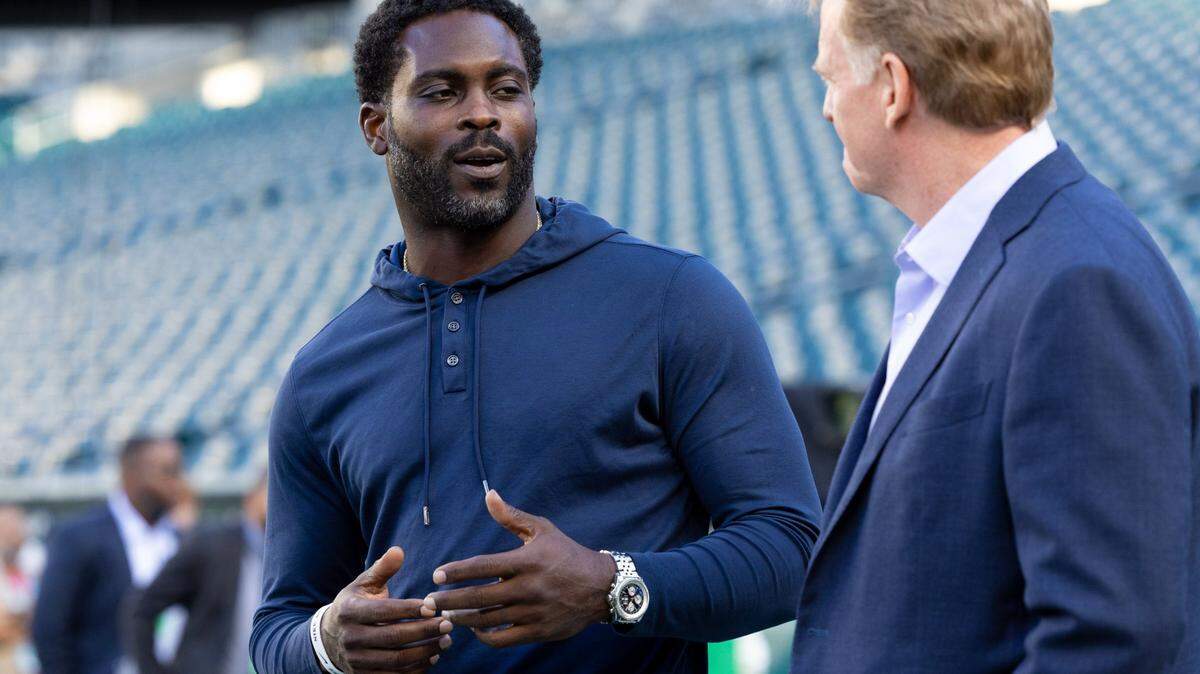 Sep 14, 2023; Philadelphia, Pennsylvania, USA; NFL commissioner Roger Goodell (R) talks with former player Michael Vick (L) before a game between the Philadelphia Eagles and the Minnesota Vikings at Lincoln Financial Field. Vick is rumored to be in talks with Sac State to be their new football head coach. Mandatory Credit: Bill Streicher-USA TODAY Sports
