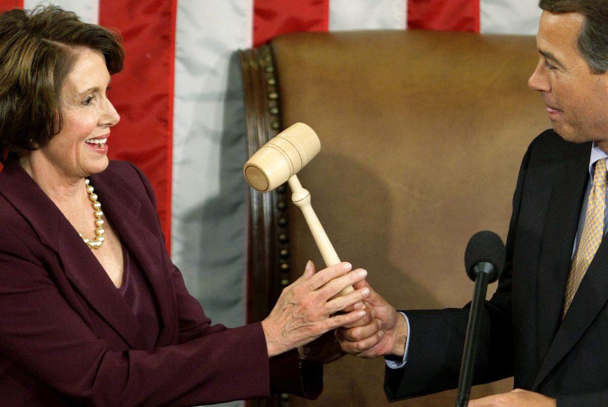 Speaker of the House Nancy Pelosi, D-Calif., takes the gavel from House Minority Leader Rep. John Boehner (R-Ohio) after becoming the first woman Speaker at a swearing in ceremony for the 110th Congress in the House Chamber of the U.S. Capitol on Jan. 4, 2007, in Washington, D.C. 