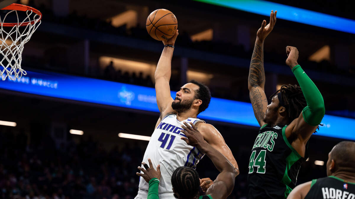 Sacramento Kings forward Trey Lyles (41) goes up for a shot as Boston Celtics center Robert Williams III (44), right, defends during the second period at the NBA basketball game Friday, March 18, 2022, at Golden 1 Center in Sacramento. Lyles missed but Sacramento Kings forward Domantas Sabonis (10) followed up to score.