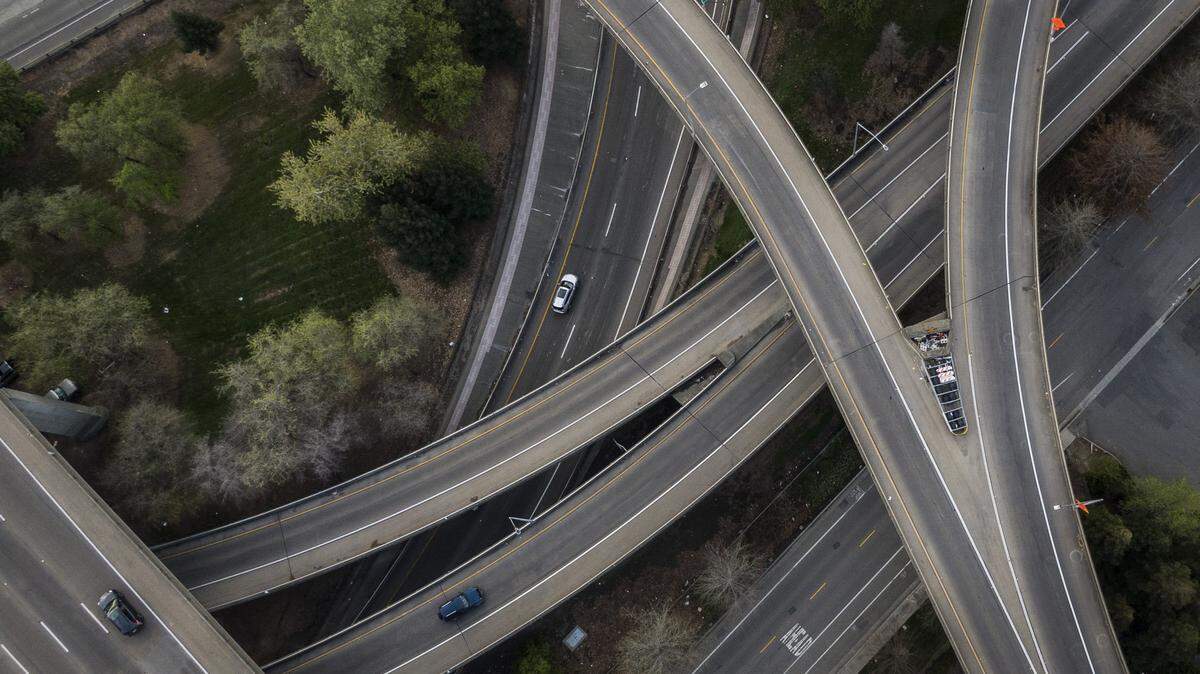 Morning rush hour traffic is light on the Interstate 5-Highway 50 interchange ramps in Sacramento, shown in a drone image from March 23, 2020, the first Monday after Gov. Gavin Newsom’s statewide shutdown order to slow the spread of the coronavirus.