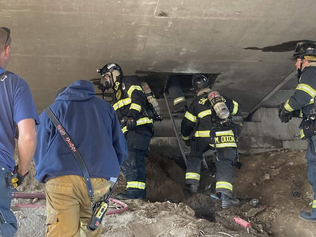 Firefighters enter the access panel where the fire started.
