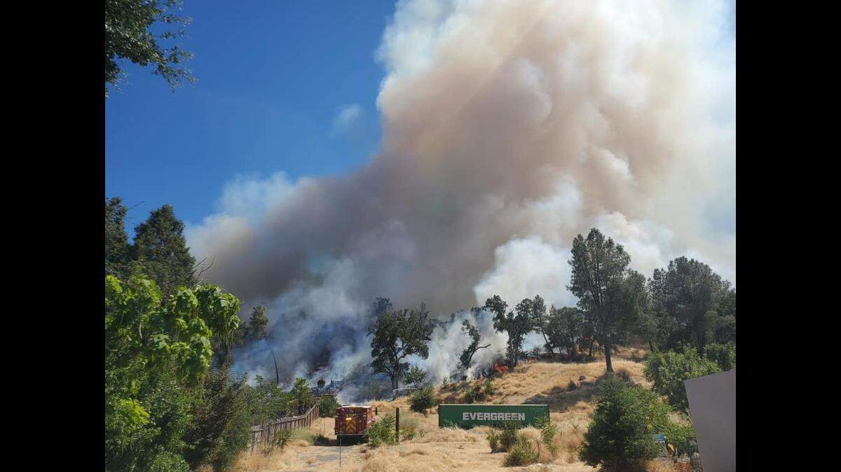 A fire burning at least 5 acres prompted mandatory evacuations Wednesday in the town of Lower Lake after spreading from a structure fire on the town’s Main Street.