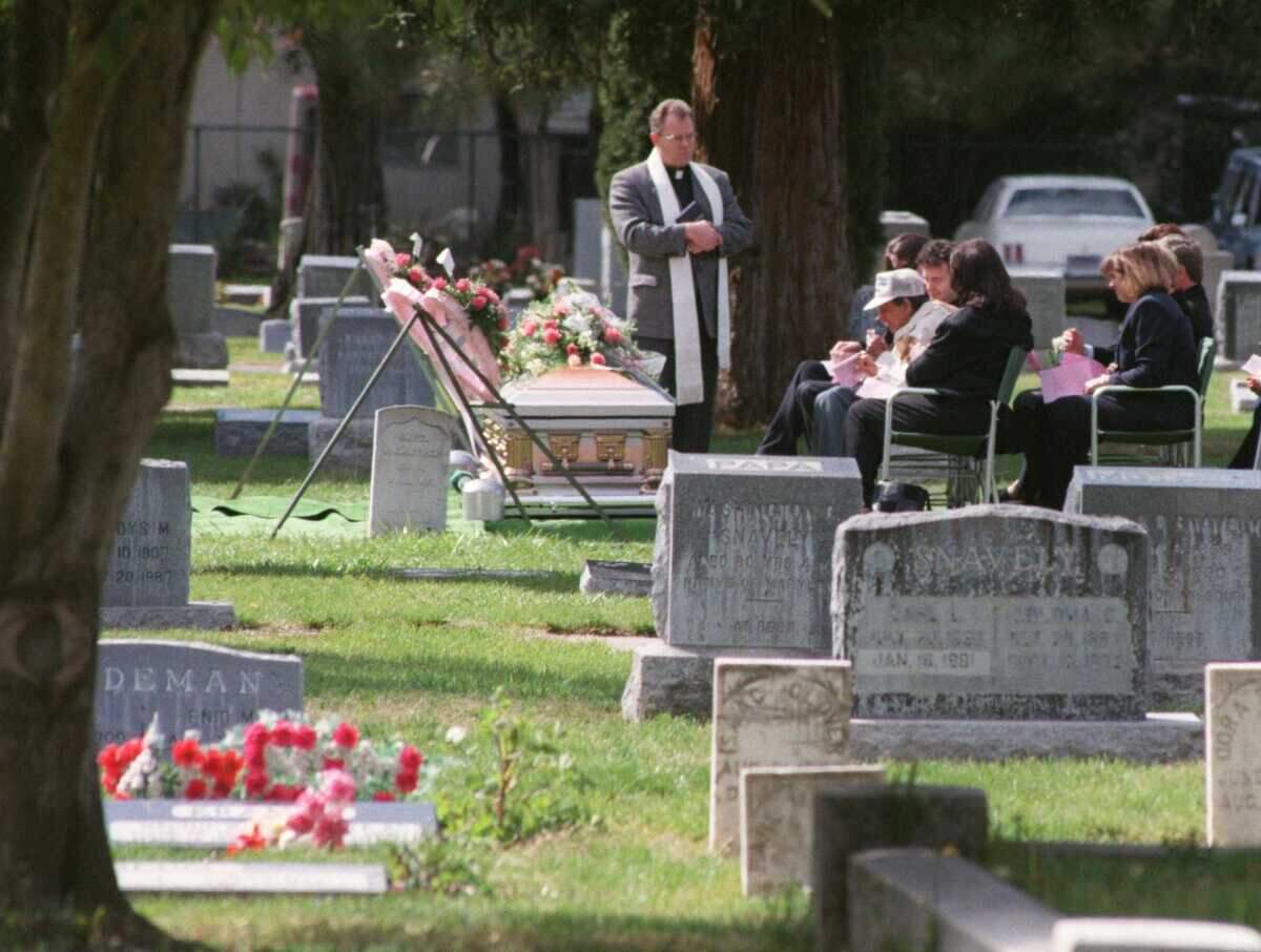A graveside service takes place at Woodland Cemetery in 1999.