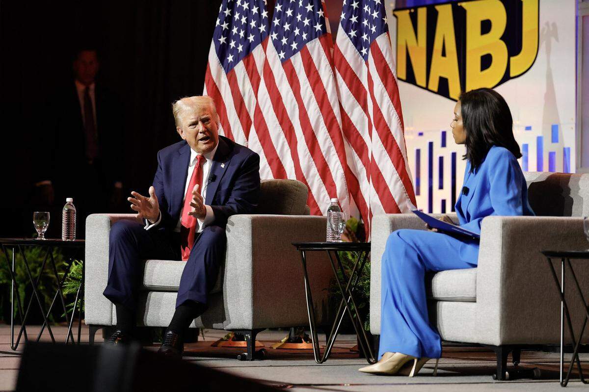 Former U.S. President and 2024 Republican presidential nominee Donald Trump answers questions as moderator and journalist Rachel Scott looks on during the National Association of Black Journalists annual convention in Chicago on Wednesday, July 31, 2024. (Kamil Krzaczynski/AFP/Getty Images/TNS)