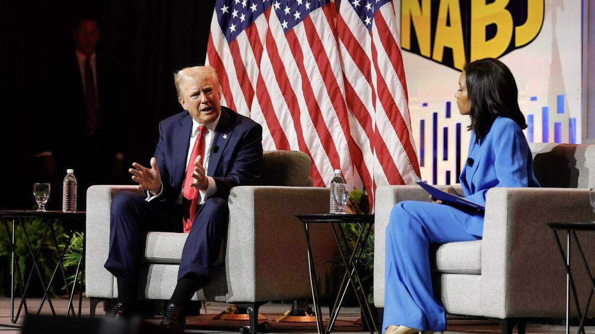 Former U.S. President and 2024 Republican presidential nominee Donald Trump answers questions as moderator and journalist Rachel Scott looks on during the National Association of Black Journalists annual convention in Chicago on Wednesday, July 31, 2024. (Kamil Krzaczynski/AFP/Getty Images/TNS)